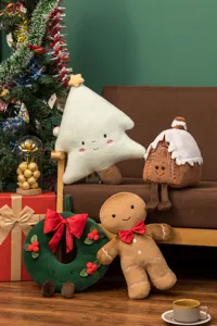 Christmas plush toy scene detail showing cute gingerbread man and tree pillow on a cozy sofa.