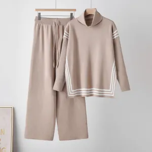 Detailed view of khaki knit turtleneck sweater and wide leg pants set with white stripes.