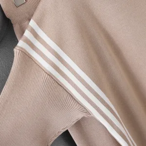 Close-up knit sweater sleeve detail with contrast stripes for women autumn winter style