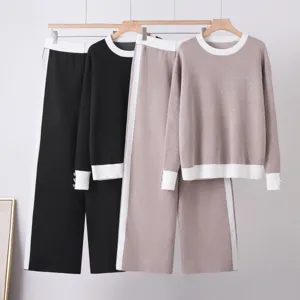 Detailed view of women knit sweater and wide leg pants set with color-block design.