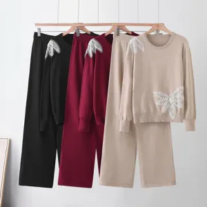Knit sweater and wide leg pants set detail, showing exquisite beaded butterfly lace design.