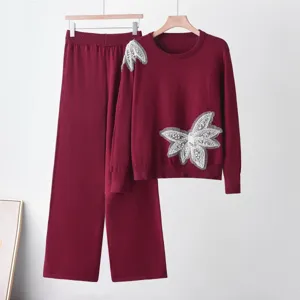 Burgundy knit sweater and wide leg pants two piece set with rhinestone butterfly detail.
