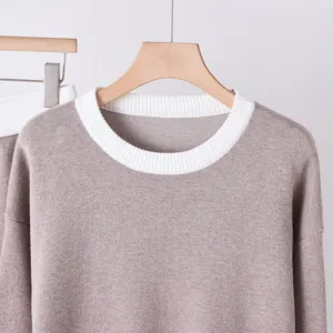 Detailed shot of womens color-blocking crewneck knit sweater with soft ribbed collar.