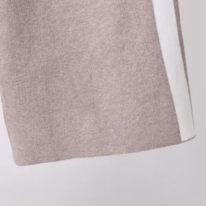 Knit fabric detail shot showcasing soft texture and clean contrast side stripe design.
