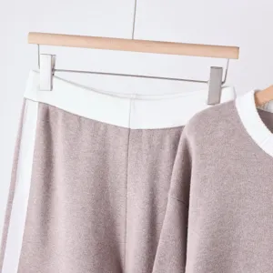 Knit two-piece set detail view, taupe sweater and wide-leg pants with white contrast ribbing.