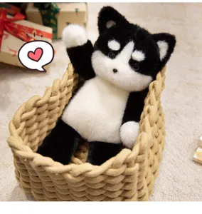 Cute black and white puppy plush toy sitting in woven basket soft stuffed animal gift