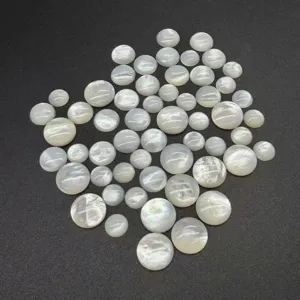Macro detail of natural white mother of pearl round flat-back cabochons for DIY