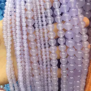 Macro view of translucent natural lavender chalcedony round loose beads in various sizes