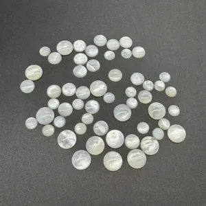 Close-up of round white mother-of-pearl cabochons for DIY jewelry making.