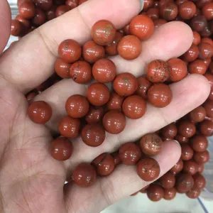 Macro view showing the natural texture of round red jasper gemstone beads without holes