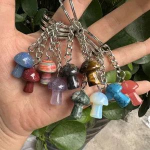 Close-up of assorted natural stone mushroom-shaped keychain pendants in various colors