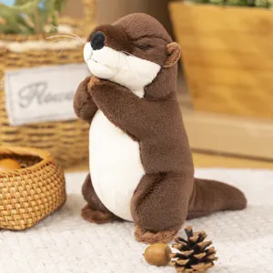Cute praying otter plush toy detail shot, soft brown stuffed animal showing lovely expression.