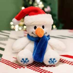 Adorable poupée en peluche bonhomme de neige de Noël avec bonnet rouge et écharpe bleue.