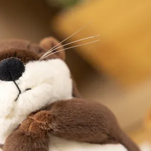 Cute plush otter toy detail shot, soft brown and white stuffed animal with lovely whiskers.