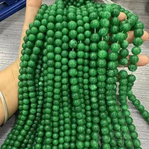 Detailed macro view of smooth green round natural stone loose beads for jewelry making