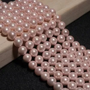 Détail de perles de nacre roses rondes et brillantes pour création de bijoux DIY