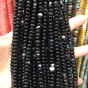 Close-up of 4x6mm black abacus beads with polished finish for DIY jewelry spacers