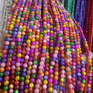 Close-up of vibrant 4mm round shell beads in multiple colors for DIY jewelry making