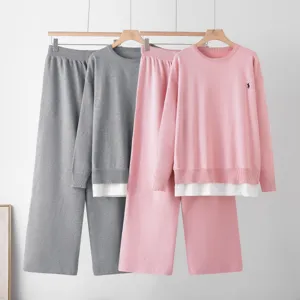 Knit two-piece outfit with round neck long sleeve top and wide leg pants detail view.
