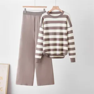 Detailed view of the striped knit sweater and wide-leg pants set in neutral brown and white.