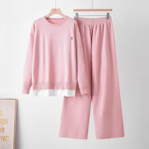 Pink knitted sweater set with long sleeve top and high waist wide leg pants for women.
