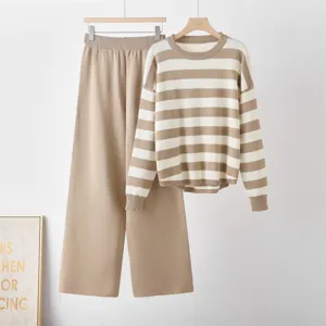 Detail shot of the beige striped long sleeve knit pullover and matching wide leg trousers outfit.