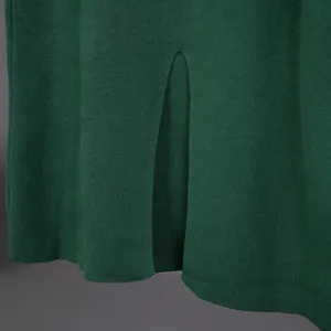 Close-up detail of dark green knit sweater hem with split design, soft textured fabric.