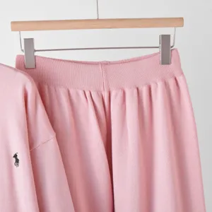 Pink knitwear set detail view featuring cozy long sleeve top and high waist casual long pants.