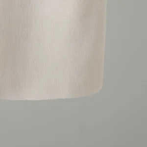 Detailed close-up of fine beige knit fabric, showing delicate texture and soft material.