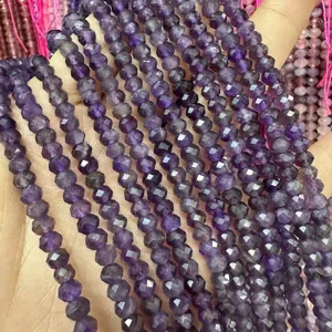 Macro detail of high-quality 3x5mm purple faceted amethyst abacus stone beads for DIY jewelry