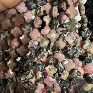 Macro view of 12mm faceted Rhodonite stone clover beads for DIY jewelry making projects.
