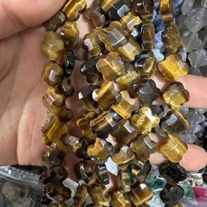 Detailed view of 12mm natural faceted tiger eye stone clover beads for DIY jewelry making