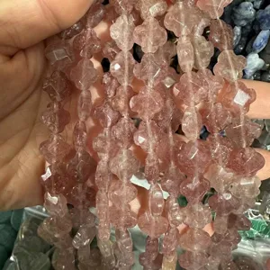 Detailed macro view of 12mm faceted four-leaf clover pink natural stone beads for DIY