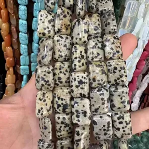 Close-up view of rectangular Dalmatian Jasper natural stone beads for DIY jewelry making