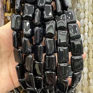 Macro view of polished rectangular double-arc black agate beads for handmade DIY jewelry