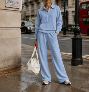 Casual light blue half-zip sweatshirt and matching sweatpants tracksuit set for women.
