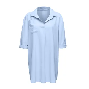 Light blue V-neck beach cover-up shirt dress detail, featuring chest pocket and rolled sleeves.