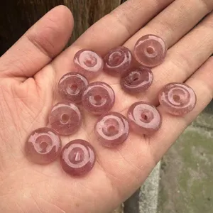 Macro detail of 15mm natural strawberry quartz pingan buckle beads for jewelry