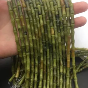 Macro detail of 5x12mm natural olive jade bamboo cylinder beads for DIY jewelry making