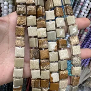 Detailed macro view of square natural stone beads with unique side grooves for DIY jewelry