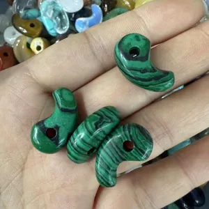 Close-up of green malachite texture comma-shaped stone pendants for DIY jewelry crafts