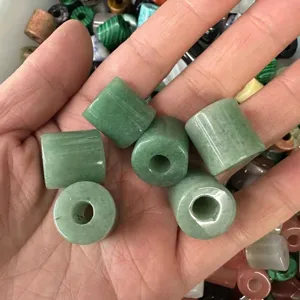 Macro view of green natural stone cylinder beads with large holes for DIY jewelry making