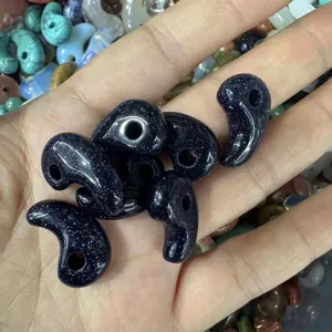 Close-up detail of glittering blue goldstone magatama comma beads for DIY jewelry