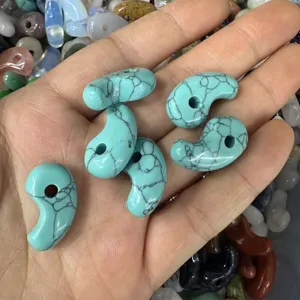 Close-up view of turquoise comma-shaped stone beads for DIY jewelry necklace making