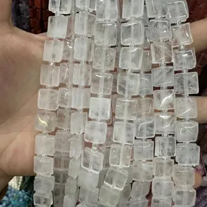 Macro detail of white quartz square beads with side grooves for DIY jewelry making.