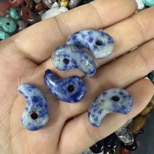 Macro view of blue and white sodalite stone comma pendants for handmade necklace charms
