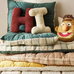 Plush letter pillow detail, cozy lamb fleece fabric, decorative pillow for sofa.