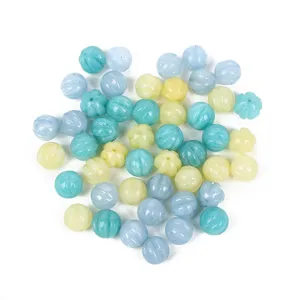 Detailed view of pastel colored pumpkin shaped ribbed loose beads for DIY jewelry making