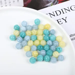 Close-up macro view of multi-colored natural stone pumpkin beads for DIY jewelry
