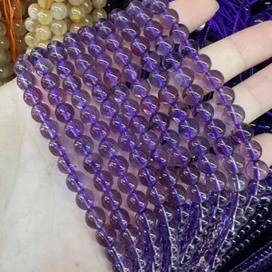 Macro view of transparent natural purple amethyst round beads for DIY jewelry making